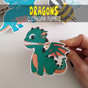 May include: A green dragon puppet with orange wings and a red mouth. The puppet is designed to be used with a clothespin. The text "DRAGONS CLOTHESPIN PUPPETS" is printed above the dragon.