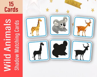 May include: A set of 15 cards for a shadow matching game featuring wild animals. The cards show a giraffe, koala, and deer, along with their corresponding shadows.