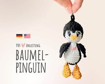 May include: Crochet penguin amigurumi pattern in PDF format. The pattern includes instructions for making a hanging penguin ornament. The pattern is available in both English and German.