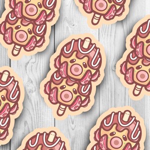 May include: A set of six colorful octopus-shaped popsicles with chocolate and white frosting. The popsicles are arranged in a row on a wooden surface.