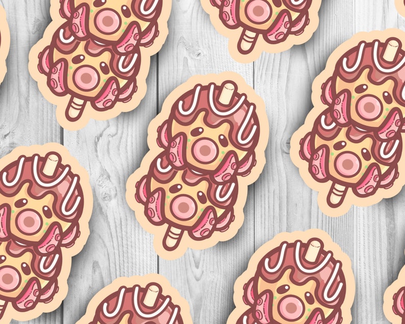 May include: A set of six colorful octopus-shaped popsicles with chocolate and white frosting. The popsicles are arranged in a row on a wooden surface.