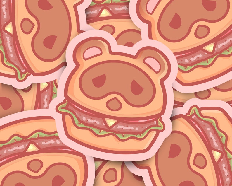 May include: A sticker featuring a cartoon animal wearing a hamburger costume. The animal has brown fur, a pink nose, and black eyes. The hamburger is a classic style with a sesame seed bun, lettuce, tomato, and a beef patty.