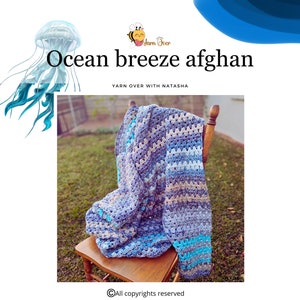 May include: A blue, gray, and white crocheted blanket draped over a wooden chair. The blanket has a striped pattern and is folded over the back of the chair. The chair is sitting on a grassy lawn. The text "Ocean breeze afghan" is written in black text above the image. The text "Yarn over with Natasha" is written in smaller black text below the image.