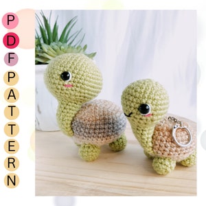 May include: Two crocheted turtle amigurumi toys. One is green with a brown and gray shell, the other is green with a brown shell and a silver key chain.