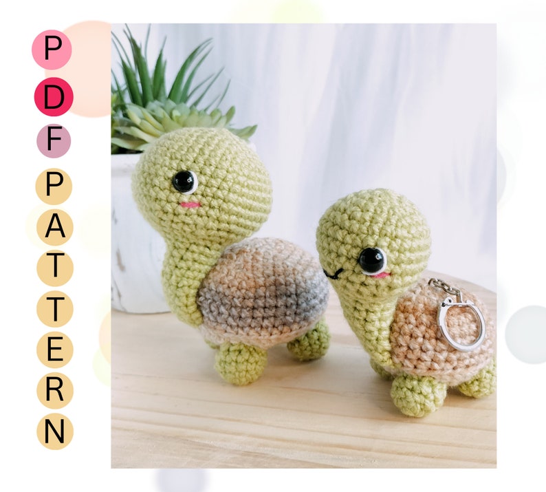 May include: Two crocheted turtle amigurumi toys. One is green with a brown and gray shell, the other is green with a brown shell and a silver key chain.