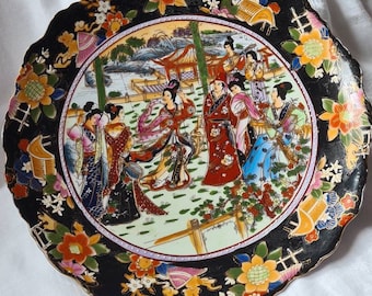 Large oriental Japanese embossed plate depicting Geisha scene.