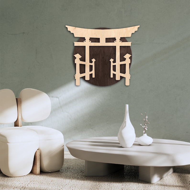May include: A wooden wall decor featuring a Japanese torii gate, a traditional gateway, with a brown circular background. The gate is made of light wood and is set against a light green wall.