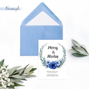 May include: A wedding invitation with a watercolor wreath of blue flowers and green leaves. The text reads "Merry & Nicolas" and includes the date, time, and location of the wedding.