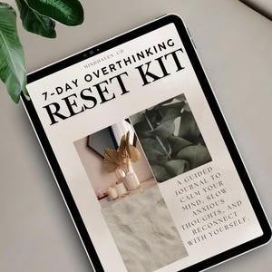 May include: A digital tablet displays the text "7-DAY OVERTHINKING RESET KIT" in bold black font. The screen shows a guided journal with images of plants and decor. The text "A guided journal to calm your mind, slow anxious thoughts, and reconnect with yourself" is also visible.