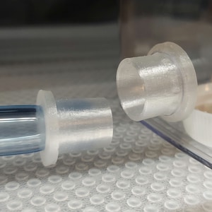 May include: Two clear plastic connectors for tubing. One connector is a straight piece, the other is a 90-degree elbow.