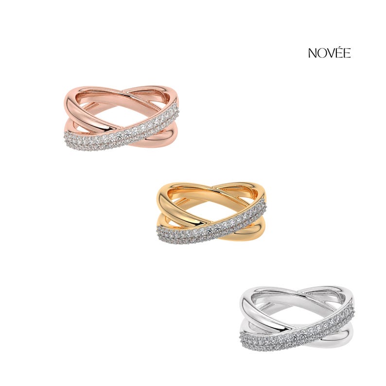 May include: Three rings in rose gold, gold, and silver, each with an intertwined design. The bands are encrusted with small, sparkling stones. The rings are displayed on a white background.