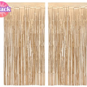 May include: Two gold foil fringe curtains, each measuring approximately 3 feet wide by 8 feet long. The curtains are made of thin strips of foil that hang from a string. The curtains are perfect for adding a touch of glamour to any party or event.