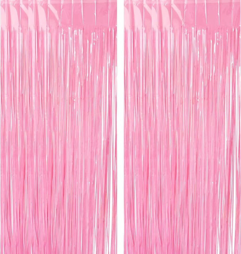 May include: Two pink metallic fringe curtains, each with a row of silver metallic strands, for party decorations.