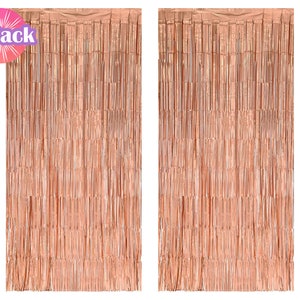 May include: Two rose gold foil fringe curtains. Each curtain is made of thin strips of foil that hang down to create a shimmering effect. The curtains are perfect for adding a touch of glamour to any party or event.