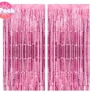 May include: Two packs of pink metallic foil fringe curtains. Each curtain is made of thin strips of foil that hang down to create a shimmering effect.