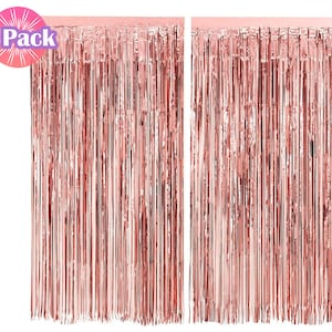 May include: Two packs of rose gold foil fringe curtains. Each curtain is made of thin strips of foil that hang down from a string. The curtains are perfect for adding a touch of sparkle to any party or event.