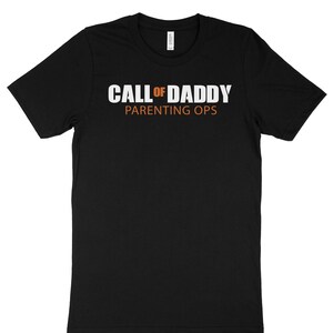 May include: Black t-shirt with white text that reads "CALL OF DADDY PARENTING OPS".