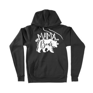May include: Black hooded sweatshirt with a white graphic of a bear with the text "Mama Bear" and an arrow on each side.