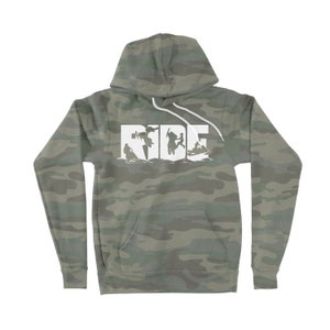 May include: A camouflage green hoodie with a white graphic of the word "RIDE" with silhouettes of people riding snowmobiles.