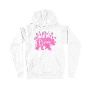 May include: White hooded sweatshirt with a pink graphic of a bear with the text "Mama Bear" and arrows on either side.