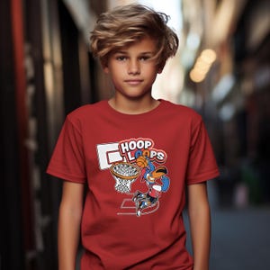 May include: A red t-shirt featuring a basketball-themed graphic. The graphic includes a basketball, a hoop, and the words "Hoop Loops". The shirt is made of a soft material and is suitable for casual wear.