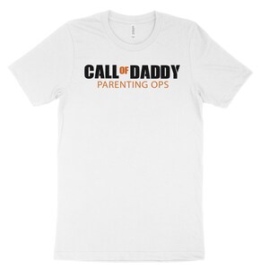 May include: White t-shirt with black text that reads "CALL OF DADDY PARENTING OPS".