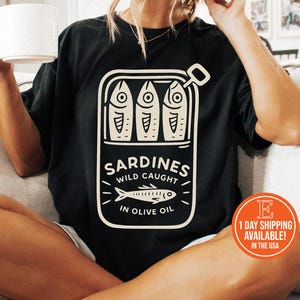 Vintage-Inspired Sardines Graphic T-Shirt, Retro Foodie Tee, Tinned Fish Shirt, Coastal Summer Tee, Fisherman Aesthetic Tee, Maritime Shirt