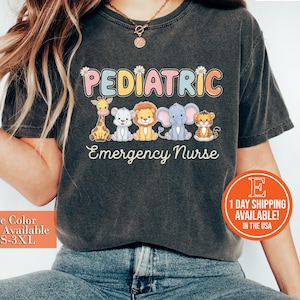 May include: A dark grey t-shirt with the text "PEDIATRIC Emergency Nurse" in rainbow colors. The text is surrounded by cartoon animals, including a giraffe, a lion, an elephant, and a tiger. The shirt is available in sizes S-3XL.