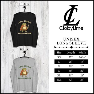 May include: Black and grey unisex long sleeve shirts with a cartoon frog wearing a cape and holding a sword. The text on the shirts reads "I AM A CONDUIT FOR NONSENSE". The shirts are hanging on black hangers.
