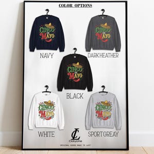 May include: Five different color options for a sweatshirt with a Cinco de Mayo graphic. The graphic features a sombrero, the words "Cinco de Mayo", and a chili pepper. The colors are navy, dark heather, black, white, and sport grey.