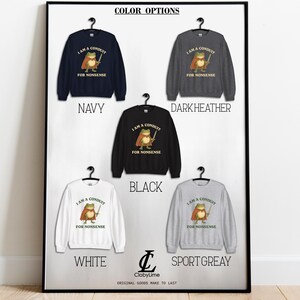 May include: A display of sweatshirts in navy, dark heather, black, white, and sport grey. Each sweatshirt features a cartoon frog with a sword and the text "I AM A CONDUIT FOR NONSENSE". The words "COLOR OPTIONS" are at the top.