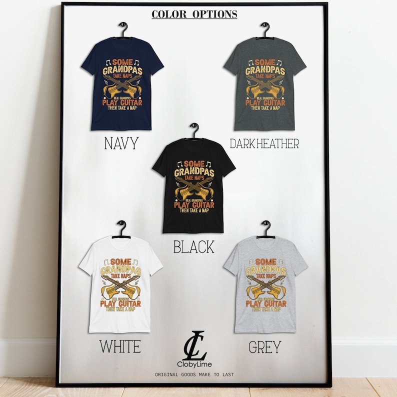May include: A framed display of t-shirts in navy, dark heather, black, white, and grey. Each shirt features the text "SOME GRANDPAS TAKE NAPS, REAL GRANDPAS PLAY GUITAR THEN TAKE A NAP" with crossed guitars. The brand logo is at the bottom.