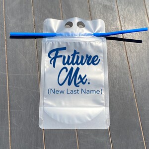 May include: A clear plastic pouch with a blue straw sticking out of the top. The pouch has the text "Future Mx. (New Last Name)" printed on it.