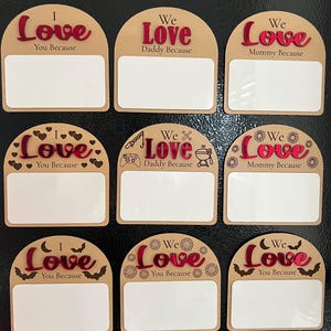 May include: A collection of nine wooden plaques with arched tops. Each plaque has a red "Love" inscription and a blank white space for personalization. The phrases "I Love You Because," "We Love Daddy Because," and "We Love Mommy Because" are included.