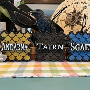 Officially licensed Fourth Wing dragon ornaments. Andarna, Tairn, and Sgaeyl.