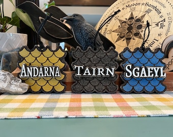 Officially licensed Fourth Wing dragon ornaments. Andarna, Tairn, and Sgaeyl.