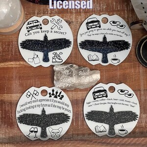 May include: Four round, white, ceramic ornaments with black silhouettes of birds. Each ornament has a different quote and image. The quotes are: "Can you keep a secret?", "You just going to ignore me while you read all day?", "I would very much appreciate it if you would stop fucking looking at my future as if she may be yours.", and "Eggs-runny, coffee-black, beer-cold, music-loud. cars, '1 floor the gas. She laughs out the rest. 'Fast'".