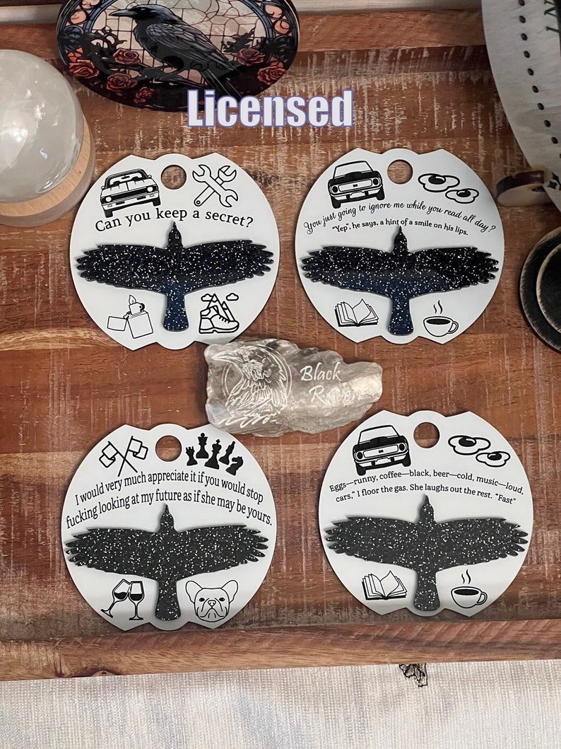 May include: Four round, white, ceramic ornaments with black silhouettes of birds. Each ornament has a different quote and image. The quotes are: "Can you keep a secret?", "You just going to ignore me while you read all day?", "I would very much appreciate it if you would stop fucking looking at my future as if she may be yours.", and "Eggs-runny, coffee-black, beer-cold, music-loud. cars, '1 floor the gas. She laughs out the rest. 'Fast'".