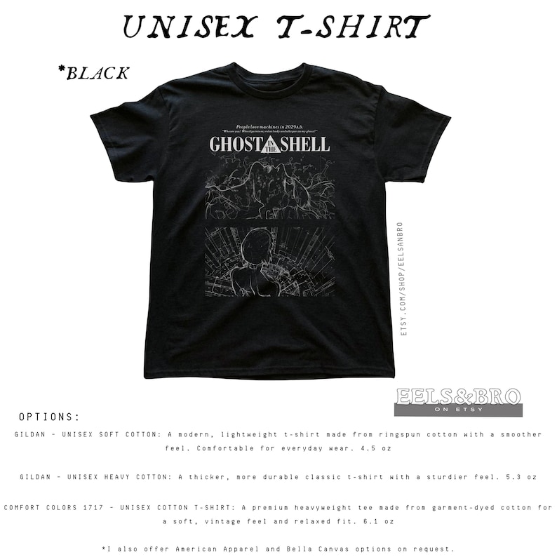 May include: A black short-sleeve t-shirt featuring a white graphic print on the chest. The design includes the text GHOST IN THE SHELL above two panels depicting stylized line art of a character and mechanical elements in a dark setting.