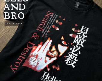 May include: A black t-shirt featuring a graphic print of a character with red eyes, a hand with a pentagram symbol, and Japanese text. The shirt includes the English text Search & Destroy, Hellsing, and a biblical verse in white and red.