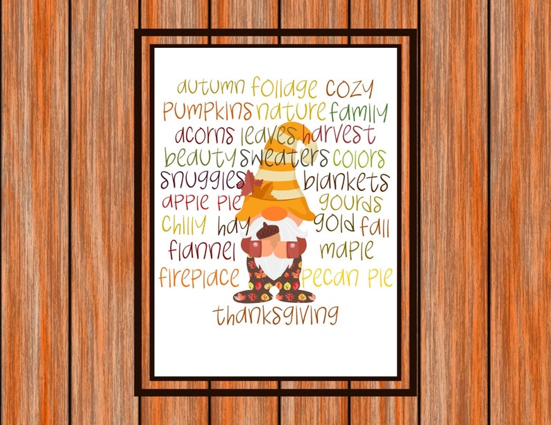 May include: A white printable sign with a gnome illustration and a list of words related to autumn, including "cozy", "pumpkins", "nature", "family", "acorns", "leaves", "harvest", "beauty", "sweaters", "colors", "snuggles", "blankets", "apple pie", "gourds", "chilly", "hay", "flannel", "gold fall", "maple", "fireplace", "pecan pie", and "thanksgiving".