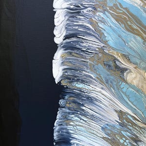 May include: Abstract painting with a black background and a vertical swath of white, blue, and gold paint. The paint appears to be flowing and swirling, creating a dynamic and textured effect.