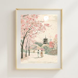 Puede incluir: Impresión de acuarela de un paisaje japonés con una pagoda, cerezos en flor y figuras con vestimenta tradicional. La obra de arte está enmarcada en un marco de madera clara, con una paleta de colores pastel suaves de rosas, verdes y cremas.
