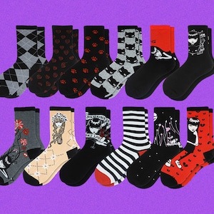 May include: A set of 12 colorful socks with various patterns, including hearts, paw prints, stripes, and illustrations of a girl with a crown and a girl with a cat. The socks are all ankle-length and have a variety of colors, including black, white, red, pink, and blue.