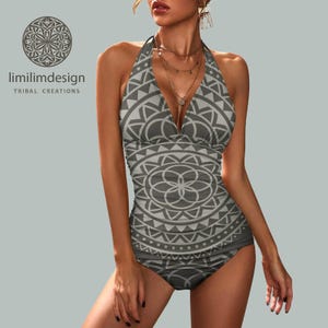 May include: Grey halter-neck swimsuit with a geometric pattern. The two-piece swimsuit features a repeating circular and triangular design. The brand name "limilimdesign TRIBAL CREATIONS" is visible in the upper left corner.
