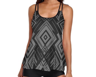 May include: A black and gray tank top with a geometric pattern. The tank top has a scoop neck and thin straps. The tank top is paired with black shorts.
