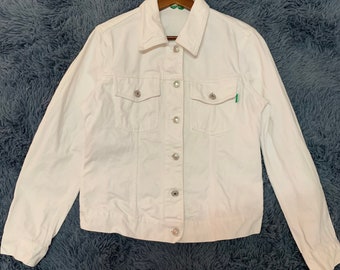 May include: A white denim jacket with a button closure and two front pockets.