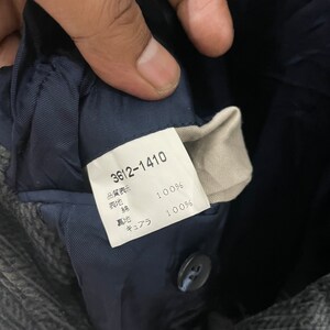 以下が含まれることがあります： 「3612-1410」と「品質表示」と黒文字で書かれた白いタグ。「品質表示」は「品質表示」と訳されます。タグには、生地の構成がウール100％とキュプラ100％と記載されています。キュプラは「キュプラ」と訳されます。