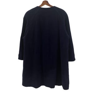 May include: A dark blue long-sleeved coat with a round neckline and a slightly flared hem.