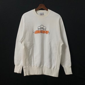 May include: White long-sleeve sweatshirt with an orange graphic of three aliens with the text "AWOL" above them.